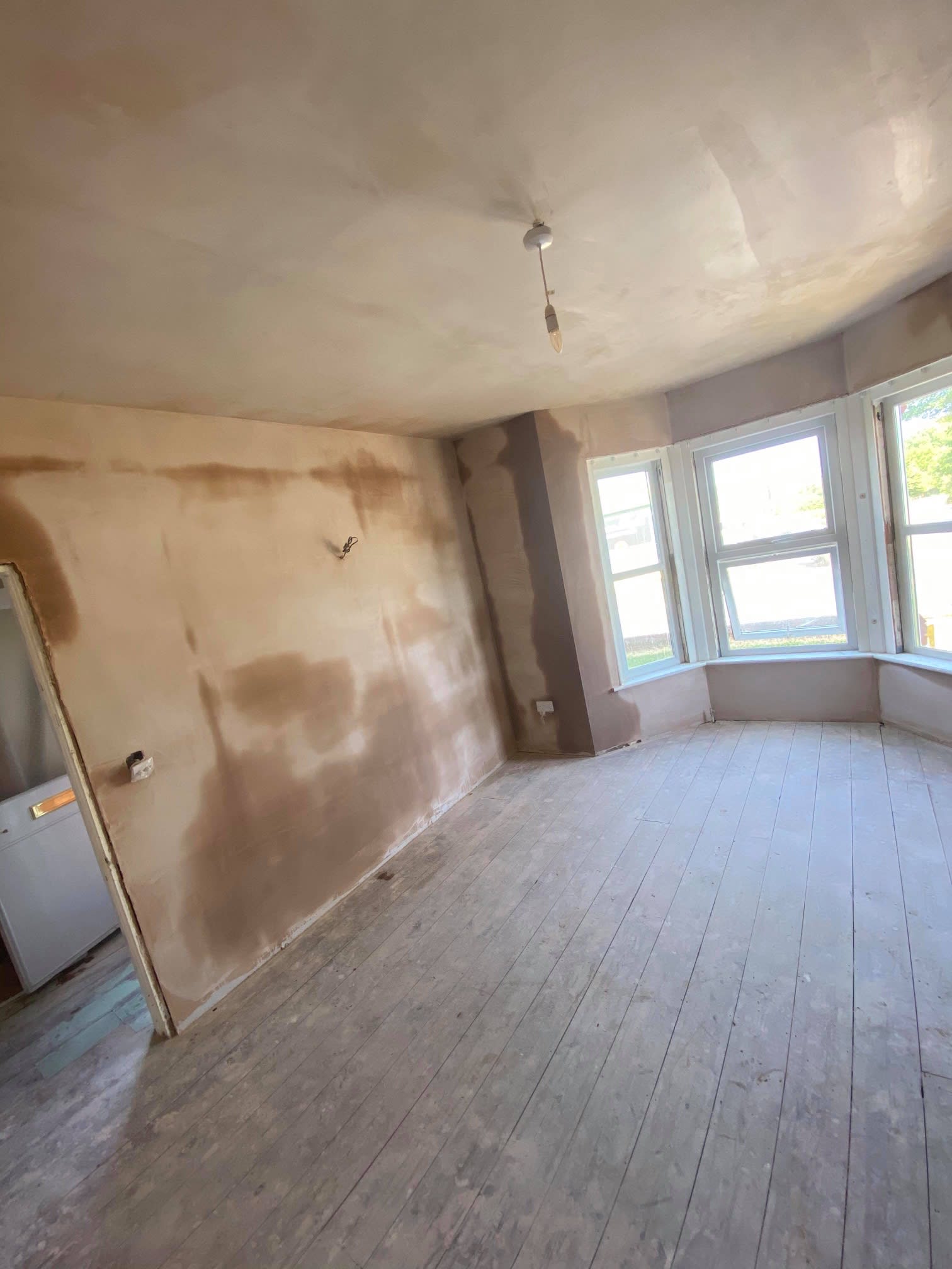 wide angle of renovated living room including plastering work