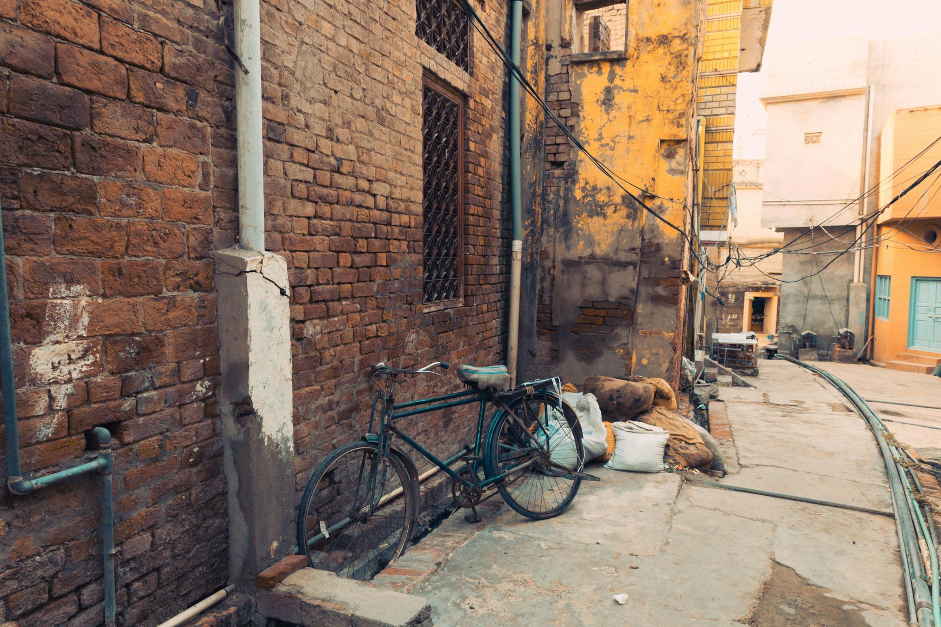 A bicycle is parked in front of a brick building.