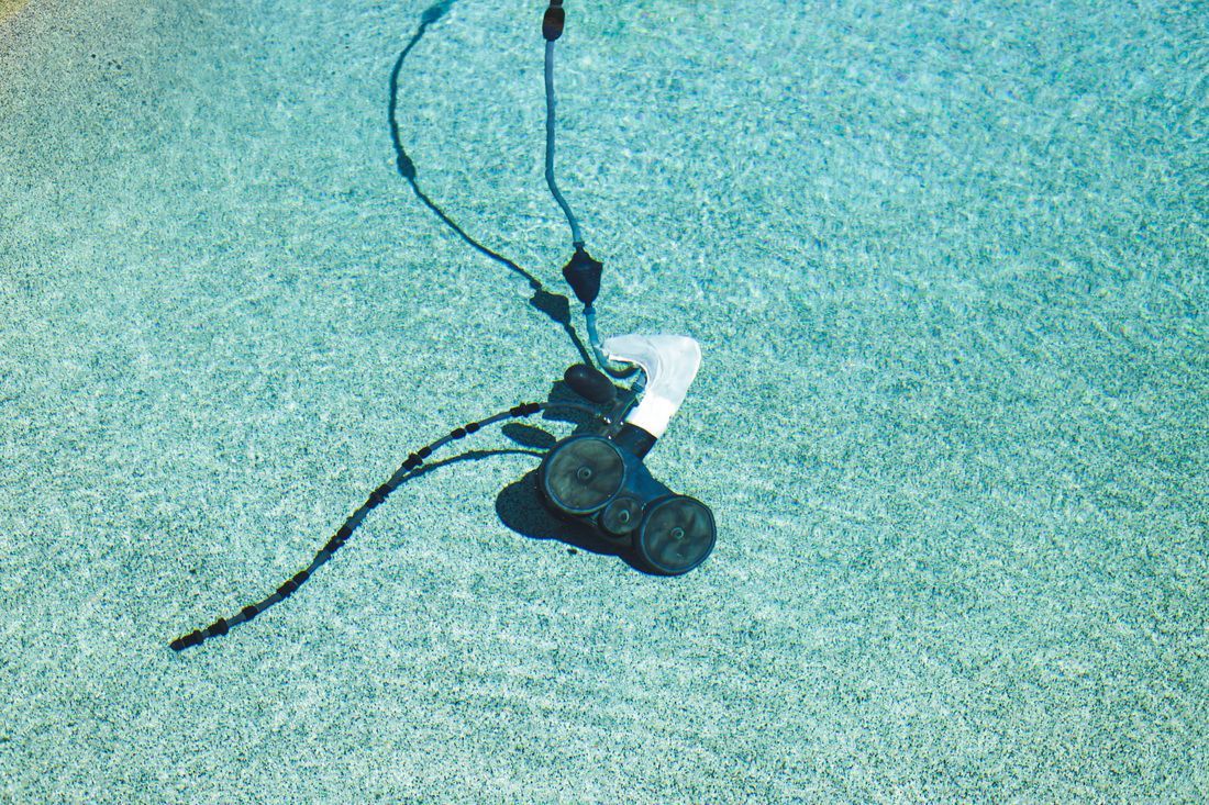 Pool cleaning vacuum, sweeping bottom of my pebble tech swimming pool.