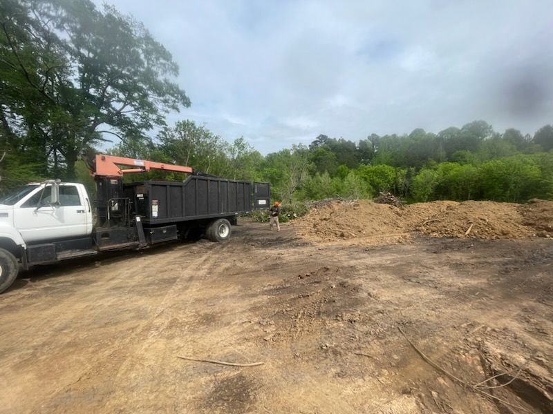 A stump grinder is cutting a tree stump in the dirt.
