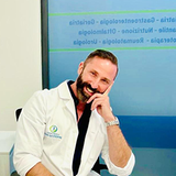 Logo del Centro Medico San Giuseppe: una figura all'interno di un cerchio blu e verde, con testo sottostante.
