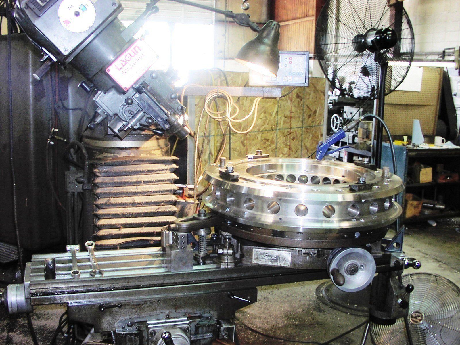 A machine in a workshop with a warning label on it