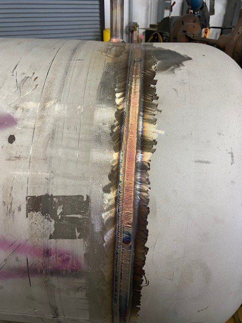 A close up of a metal pipe with a hole in it.