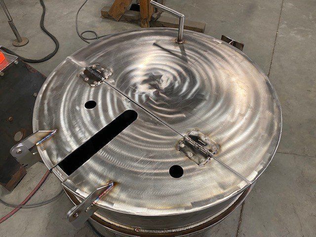 A large metal object is sitting on a concrete floor.