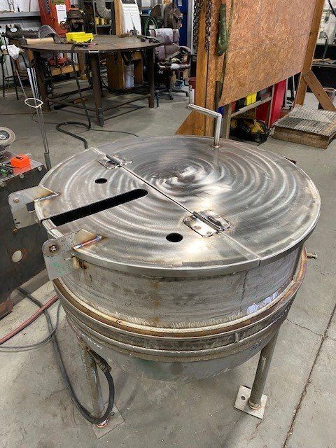 A large metal object is sitting on the floor in a room.