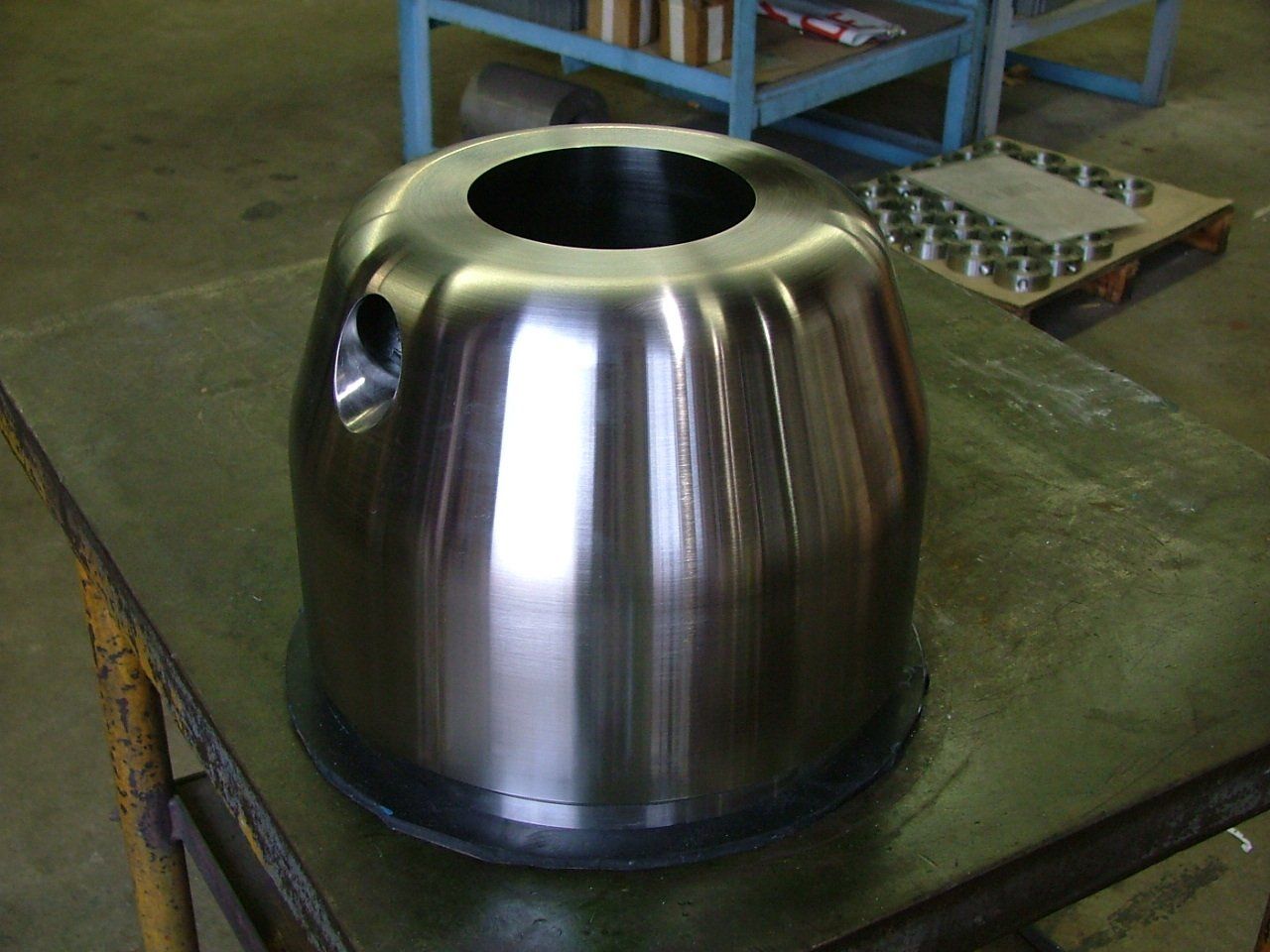 A metal object with a hole in the middle is sitting on a table.