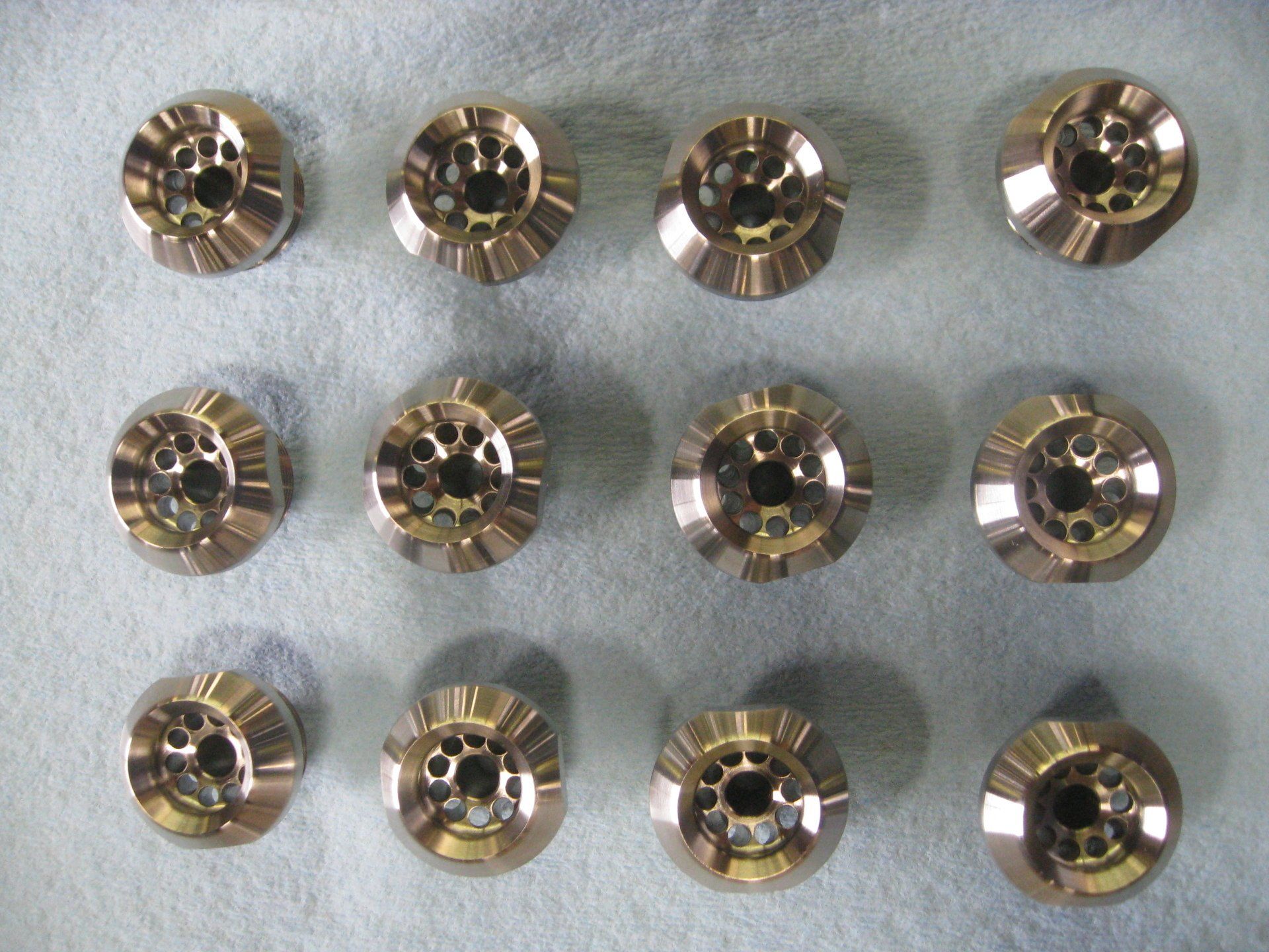 A bunch of metal buttons with holes in them