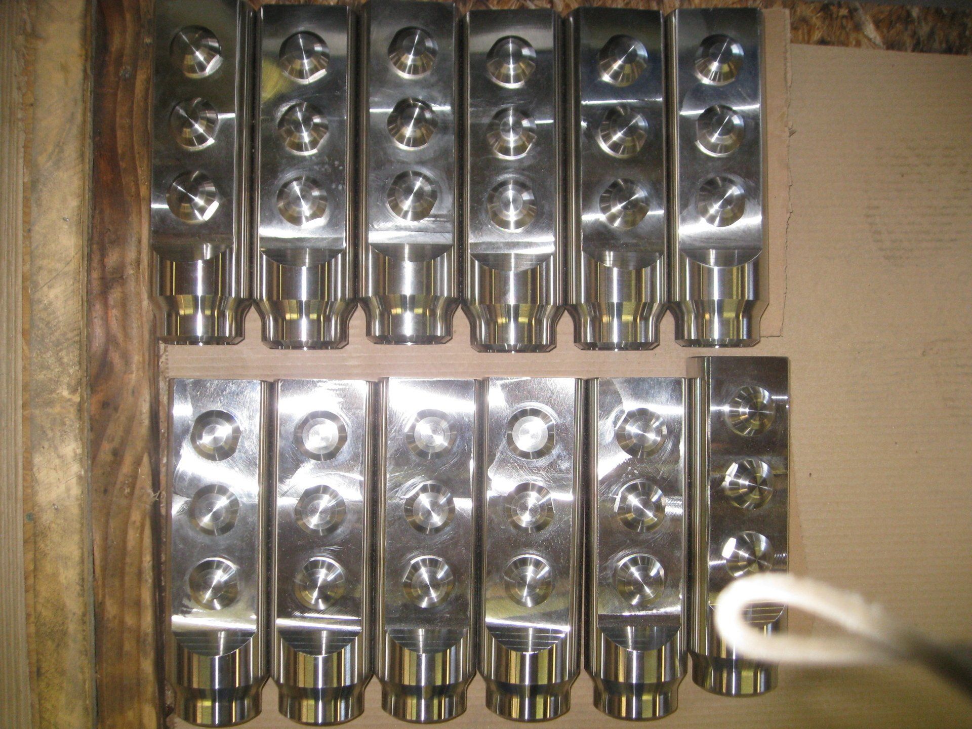 A bunch of metal pieces are lined up on a table