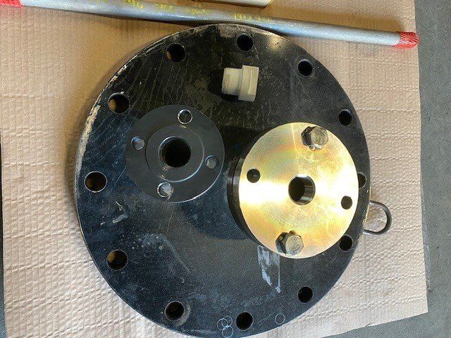 A piece of metal with holes in it is sitting on a piece of cardboard