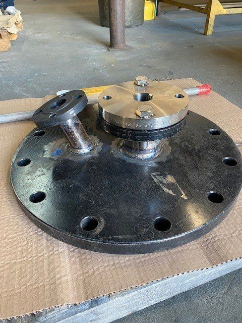 A piece of metal is sitting on top of a piece of cardboard.