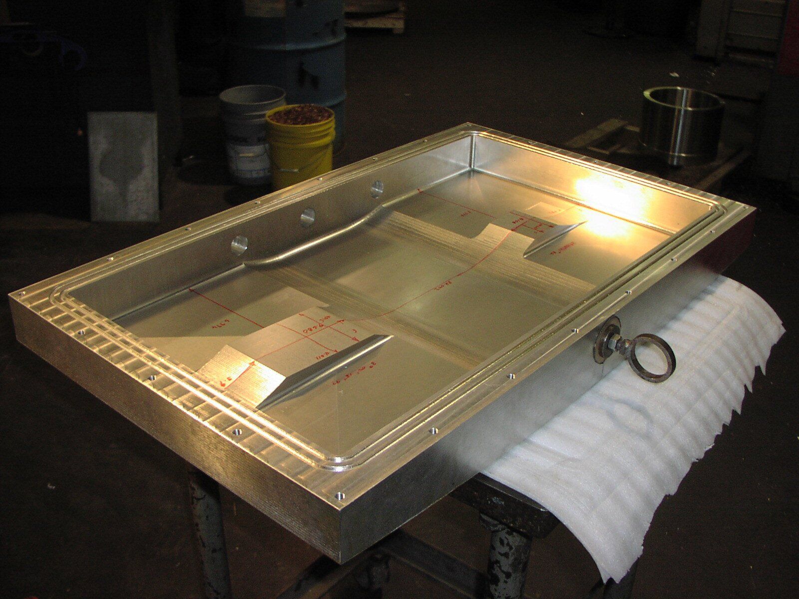 A metal tray with a handle is sitting on a table