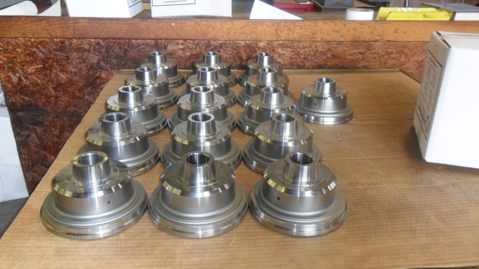 A bunch of metal parts are sitting on a wooden table