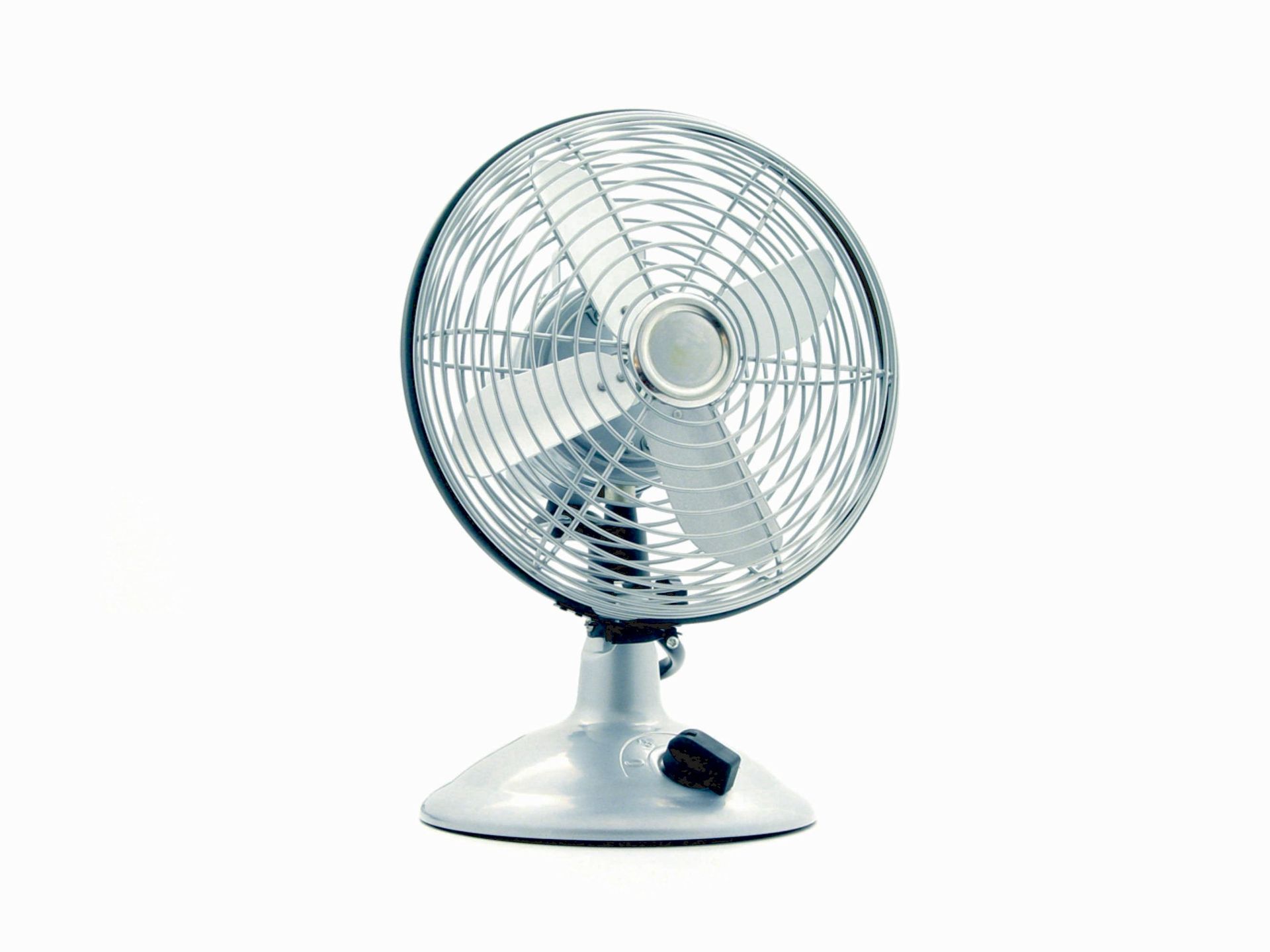 Ventilador de escritorio con aspas y jaula de metal, base de color blanco, sobre fondo blanco.