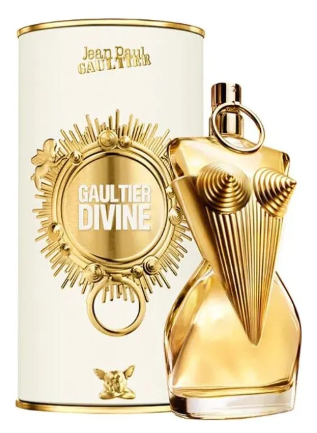 Frasco dorado del perfume Jean Paul Gaultier Divine, junto a un bote a juego blanco y dorado.