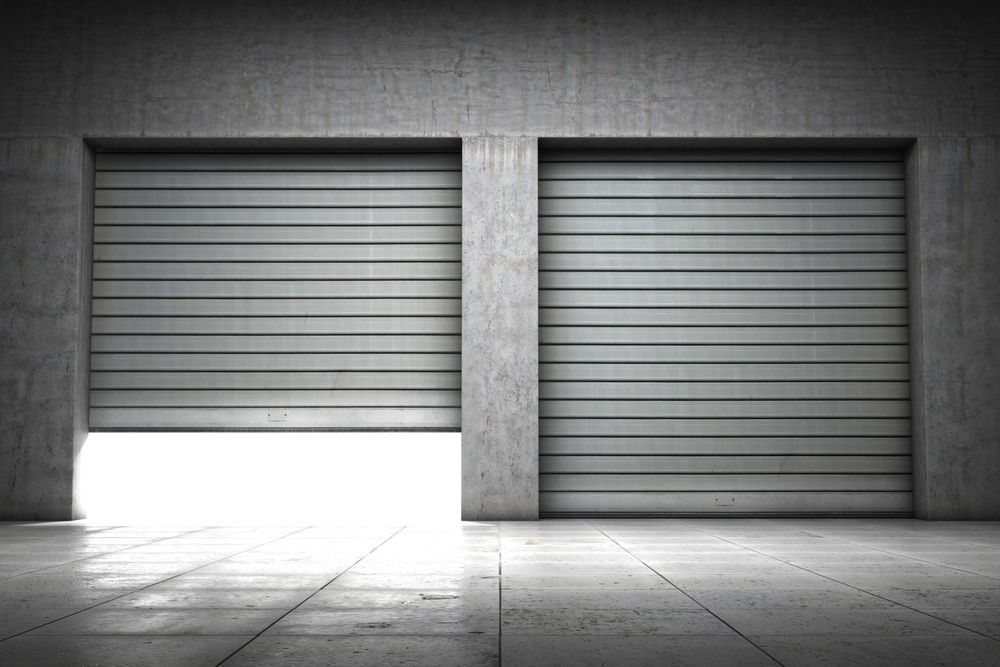 There is a light Coming out of one of the Garage Doors — Upright Garage Doors In Chipping Norton, NSW