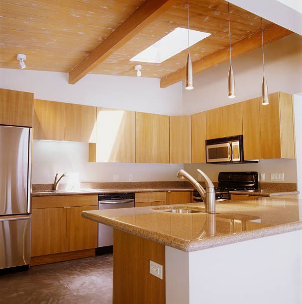 A Kitchen with Stainless Steel Appliances and Wooden Cabinets — Inverness, FL — First Class Refinishing 