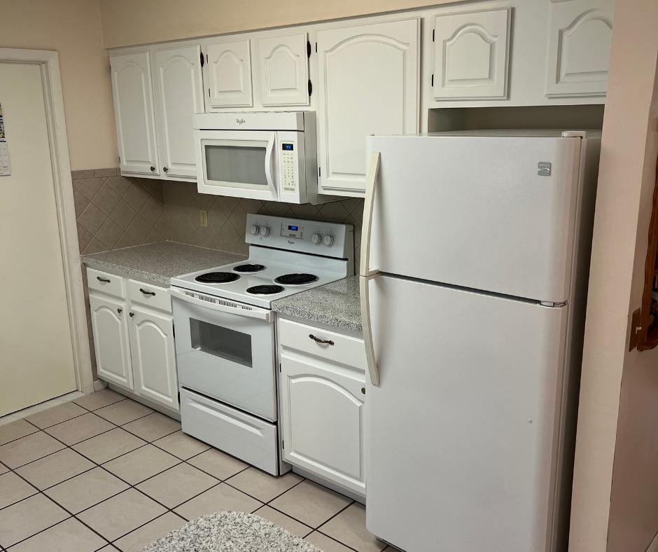 A Kitchen with White Cabinets , a Stove , a Refrigerator , and A Microwave — Inverness, FL — First Class Refinishing 