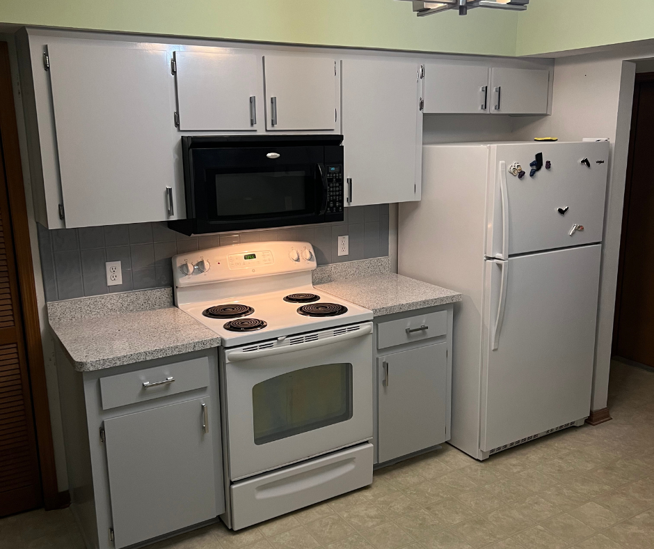 A Kitchen with A Stove , Refrigerator , Microwave and Cabinets — Inverness, FL — First Class Refinishing 