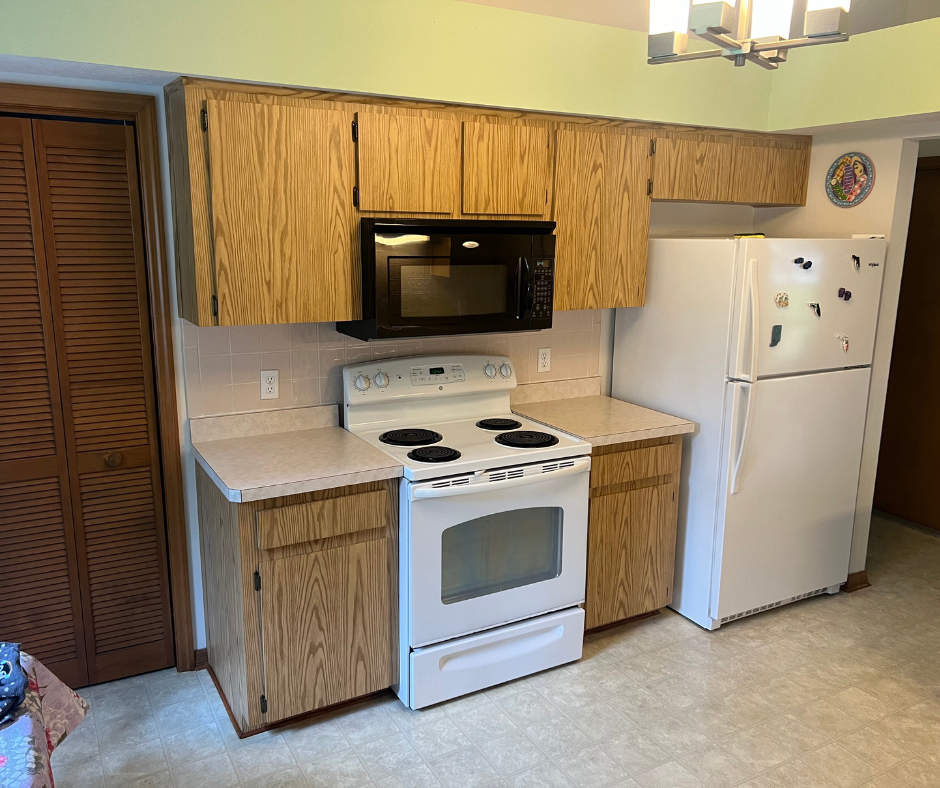 A Kitchen with A Stove , Microwave , Refrigerator and Cabinets — Inverness, FL — First Class Refinishing 