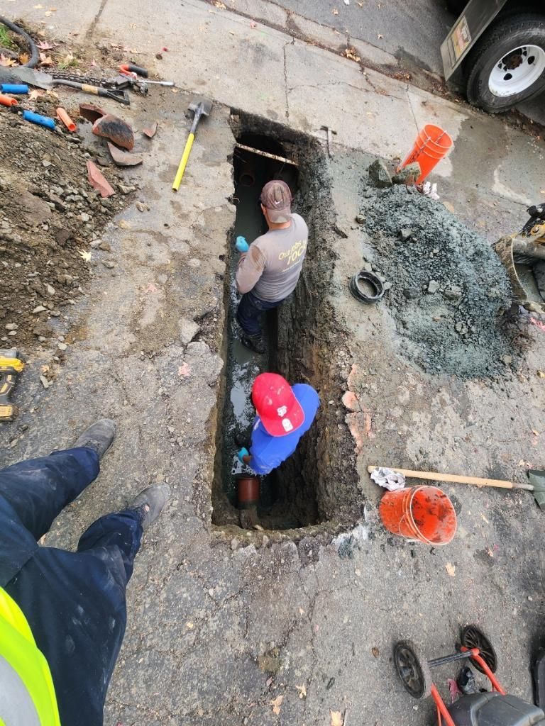 a man wearing a gray shirt that says ' emergency services ' on it — Concord, CA — Warranted Plumbing Services Inc.