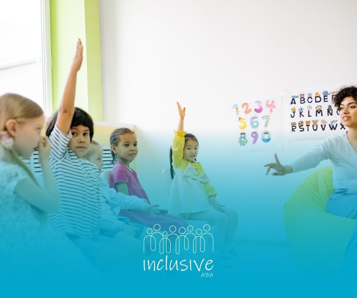 Children in a classroom raise hands, teacher gestures. Numbers, letters on wall; bright blue lower right.