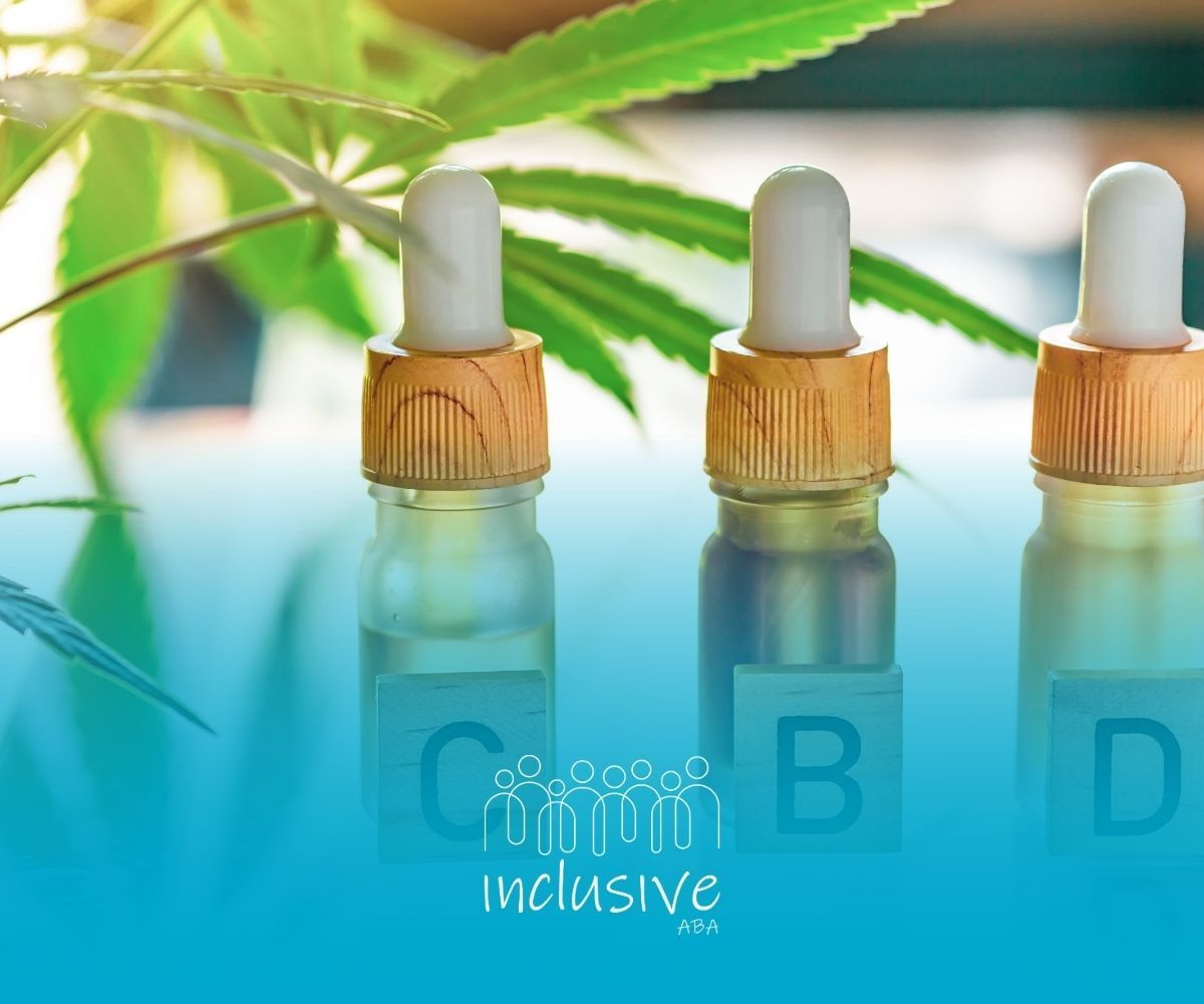 Three CBD oil bottles with droppers and wooden letter blocks spelling CBD near a cannabis leaf.