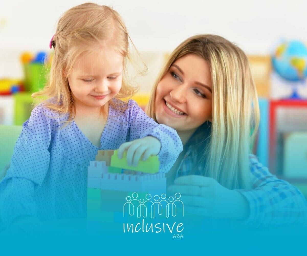 A BCBA helping a young girl with autism build with colorful blocks in ABA therapy.