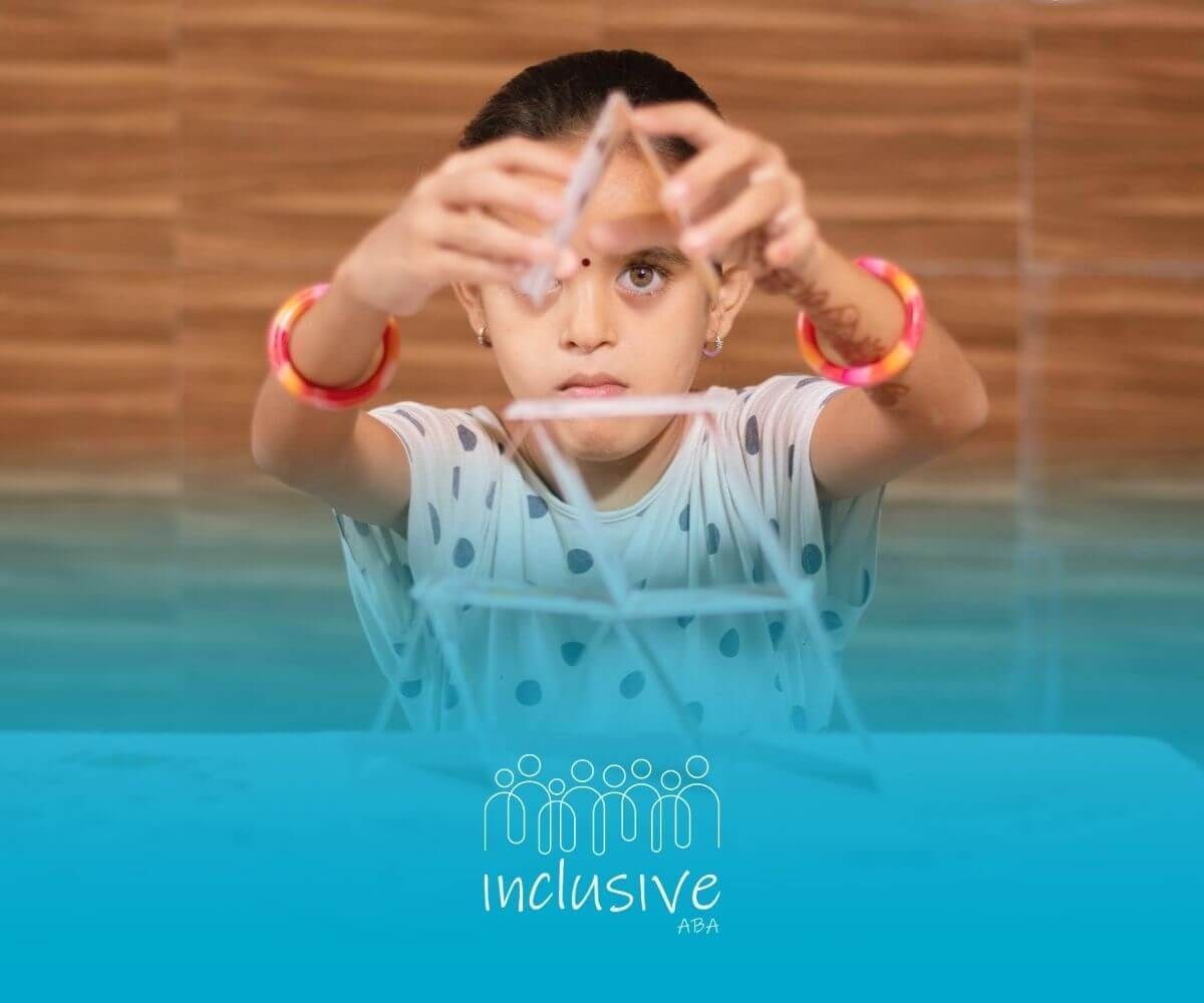 Girl with autism concentrating while building a tower out of playing cards.
