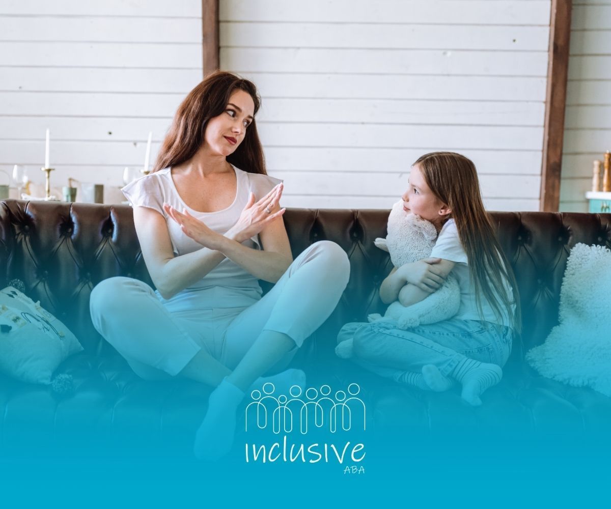 Woman with arms crossed talking to a child holding a stuffed animal on a couch.