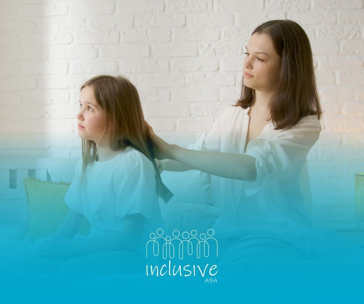 An ABA therapist brushing an autistic girl’s hair on bed by window during in-home ABA therapy in CO.