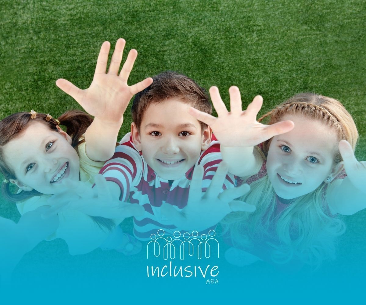 Three smiling children reaching towards the camera against green grass, text reads 