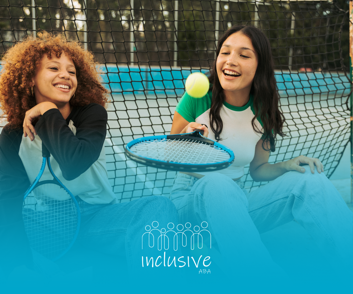 Two young women are playing tennis on a tennis court.