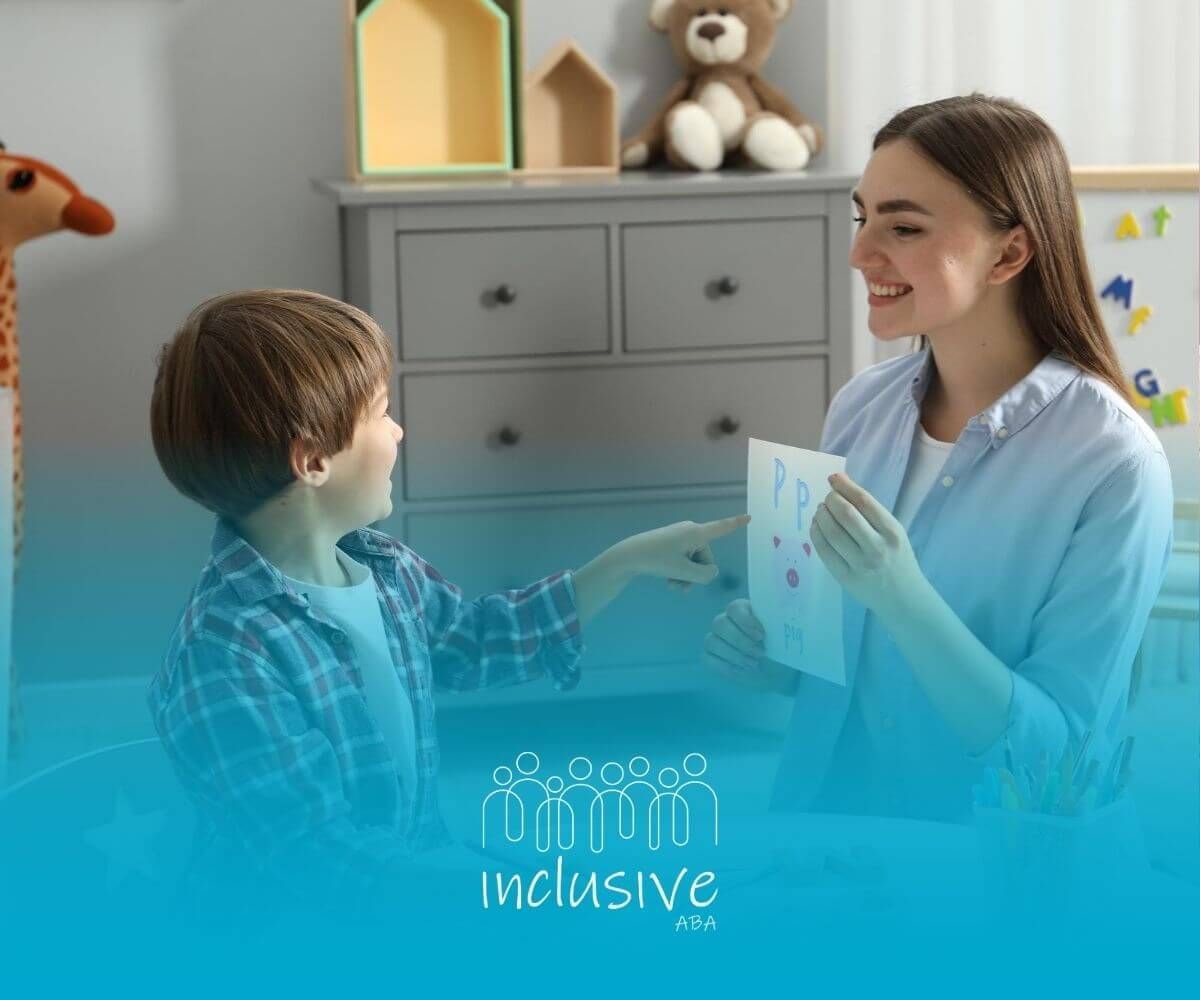 An ABA therapist is sitting at a table with a child in ABA therapy.