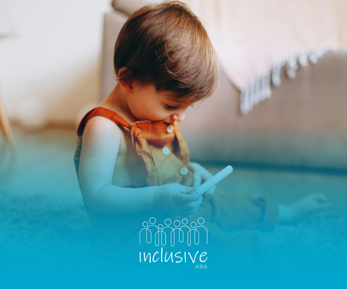 Child sitting on the floor, looking down at a mobile device; teal overlay with “inclusive” logo.