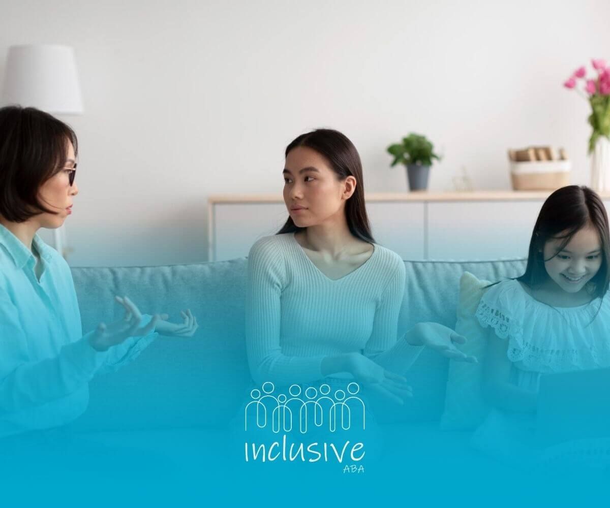 A family sits on a couch, engaged in conversation with a child on a laptop.