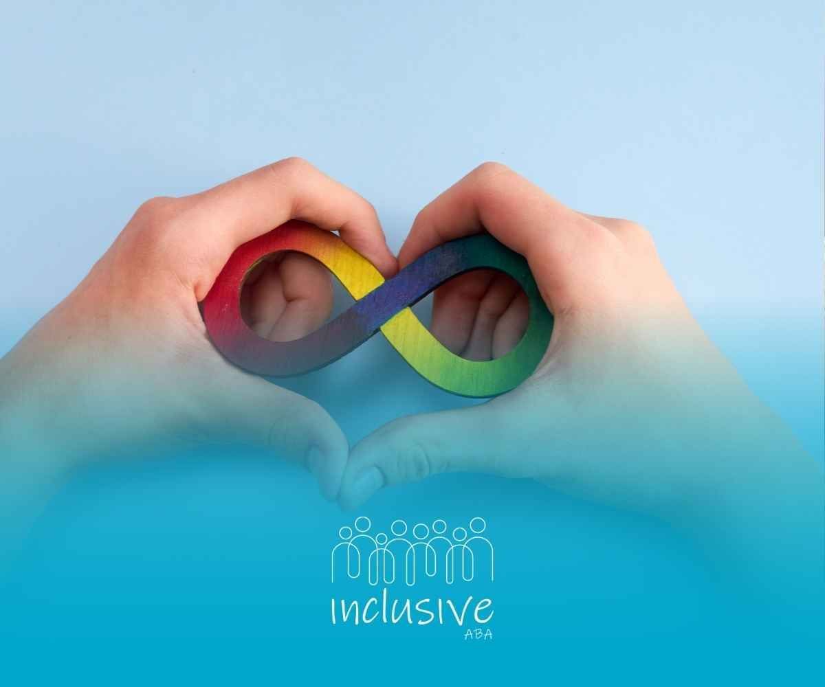 Hands forming a heart around a rainbow infinity symbol, symbolizing inclusivity.