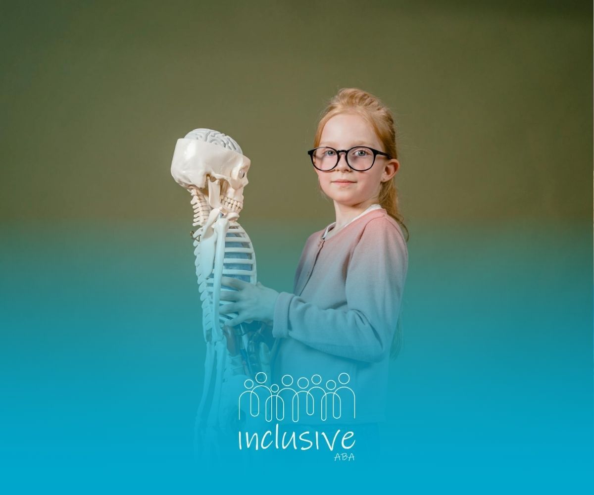 An autistic girl with high IQ holding a small skeleton model during ABA therapy session in Nebraska