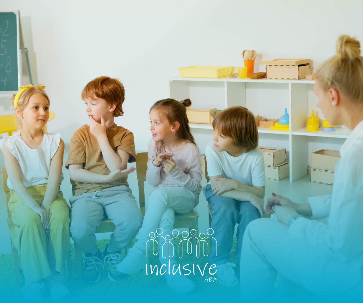 Four young children sitting on small chairs talking with a theraphist in a bright classroom