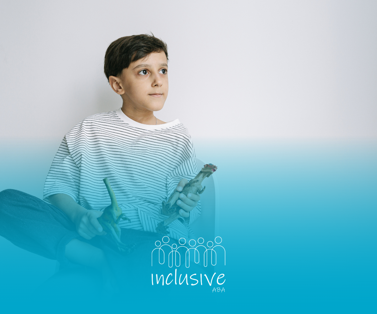 Boy sitting and looking upwards, holding a small toy in front of a blue gradient background, with the word