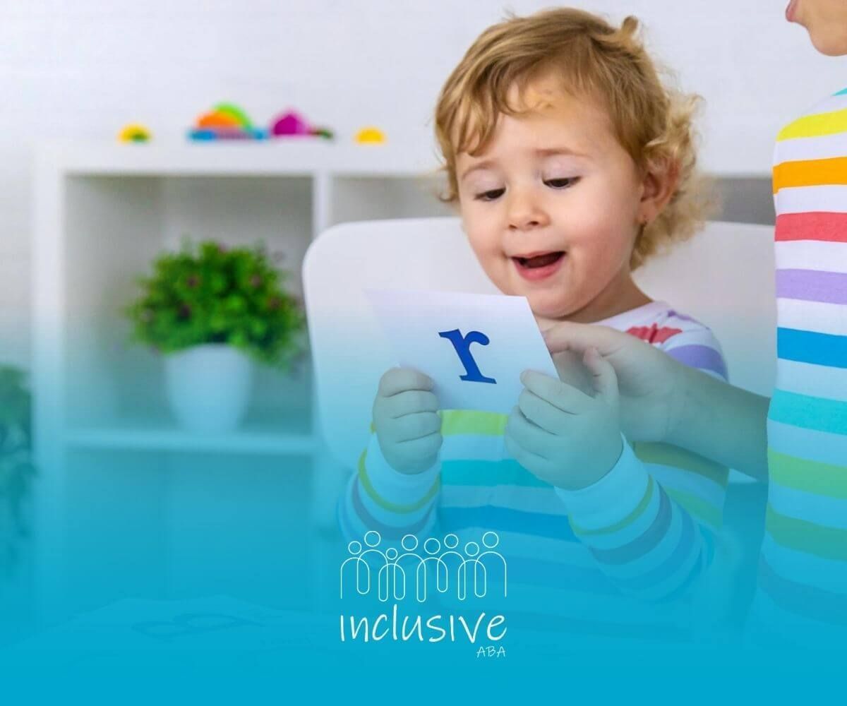 An autistic boy with soapy hands, smiling while standing in a kitchen sink area.