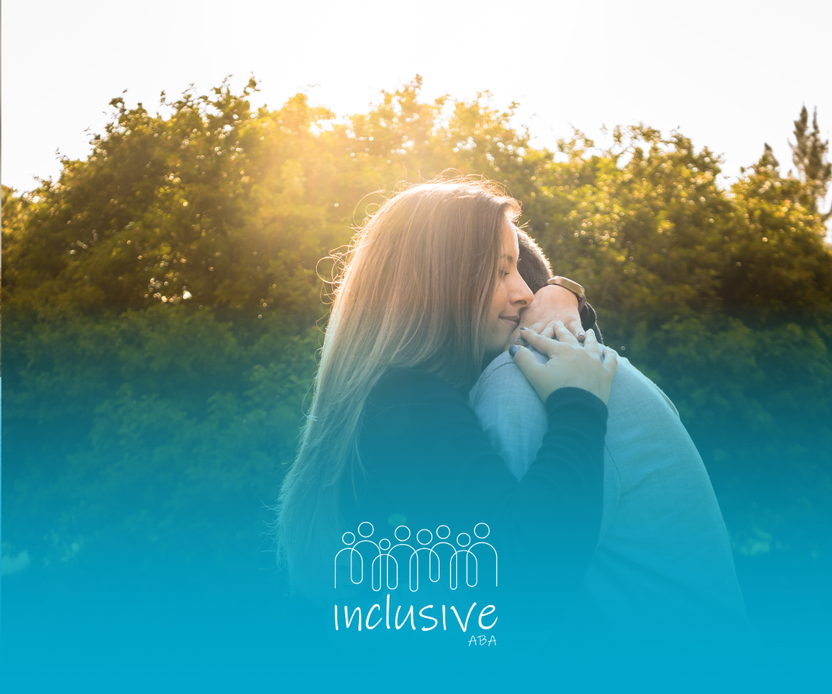 Two people embracing warmly outdoors at sunset