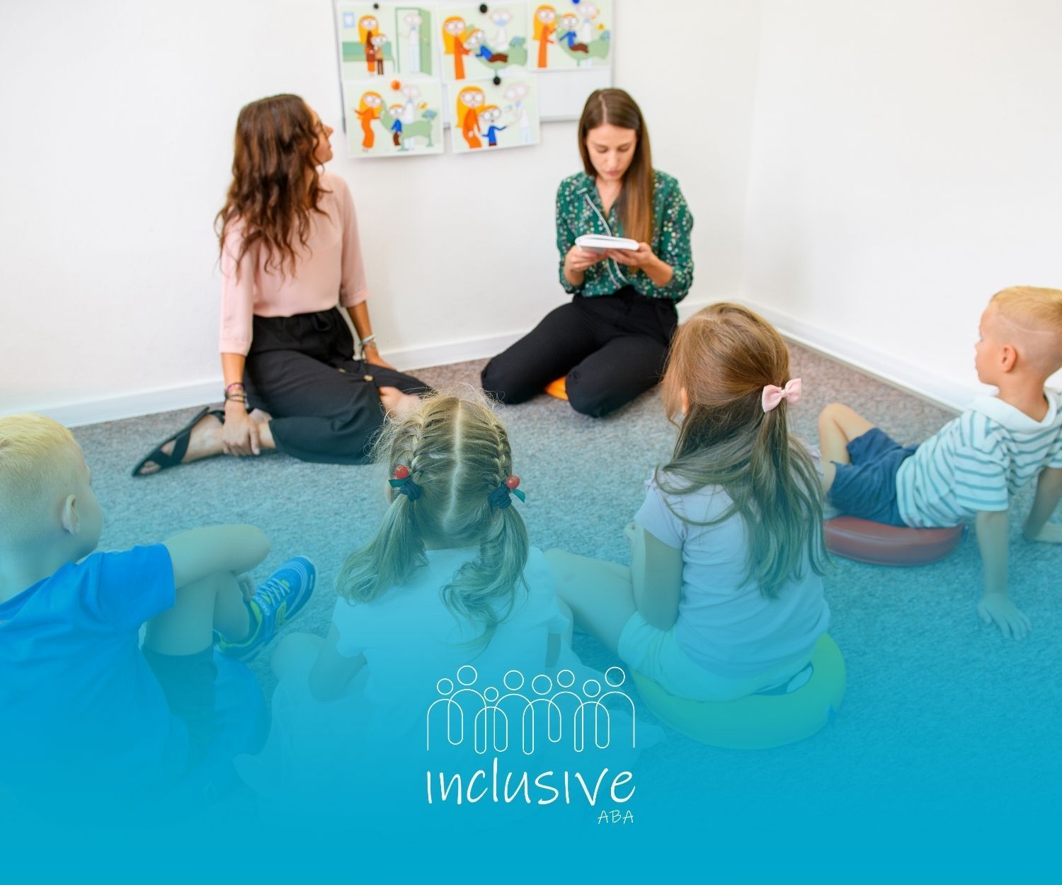 Two adults sit with four children in a circle; all are looking at the adult with a notepad.