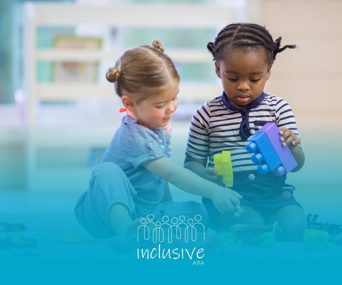 Two children playing with colorful blocks on a floor.