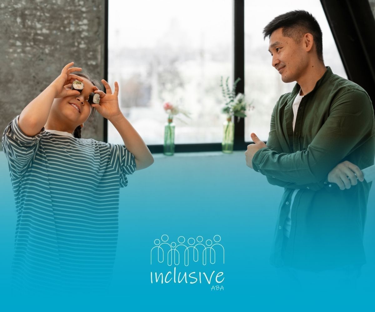 A male ABA therapist and son interacting while the son playfully holds up sushi pieces to his eyes.