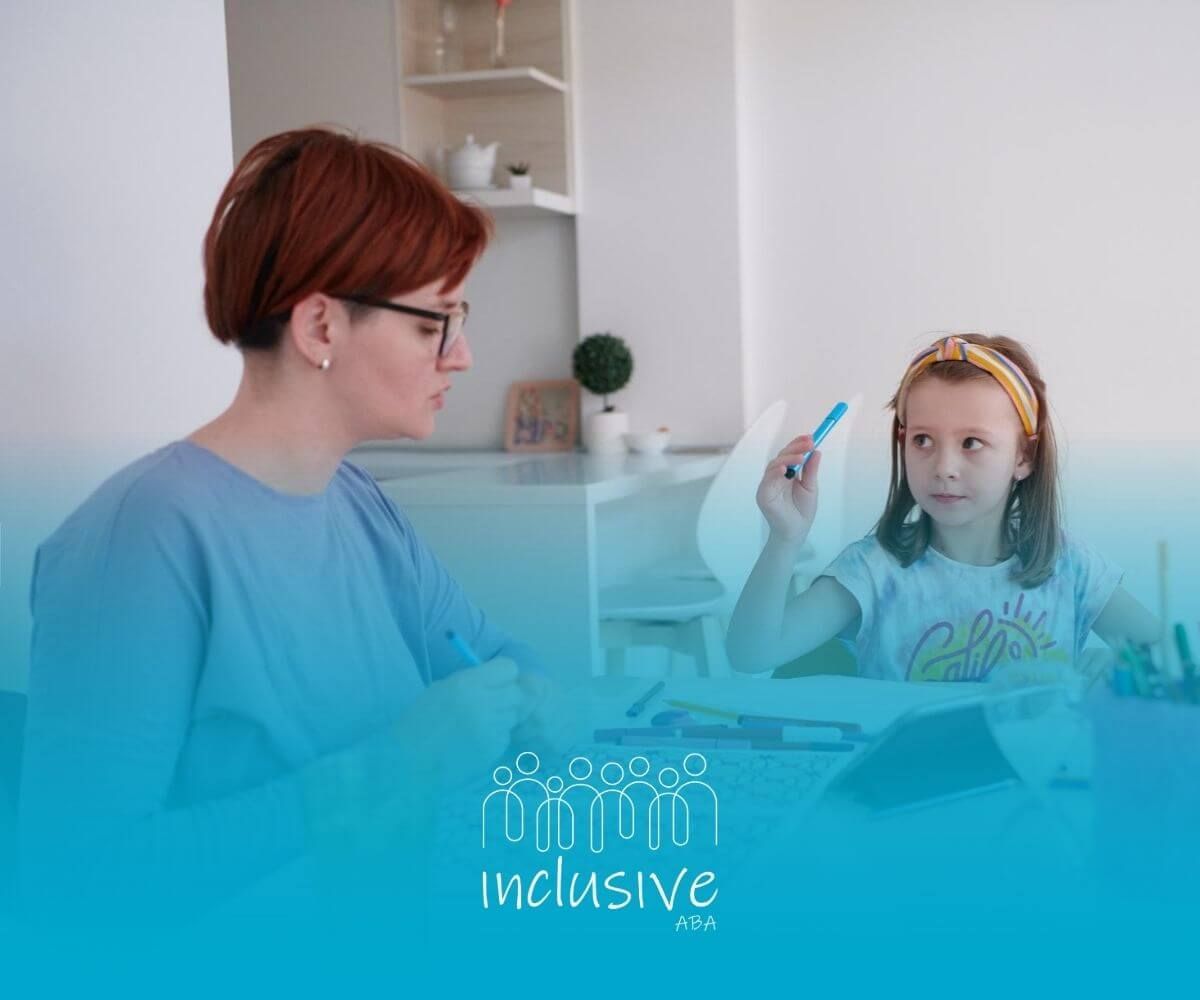 An ABA therapist works with a young girl with autism holding a marker during a lesson.