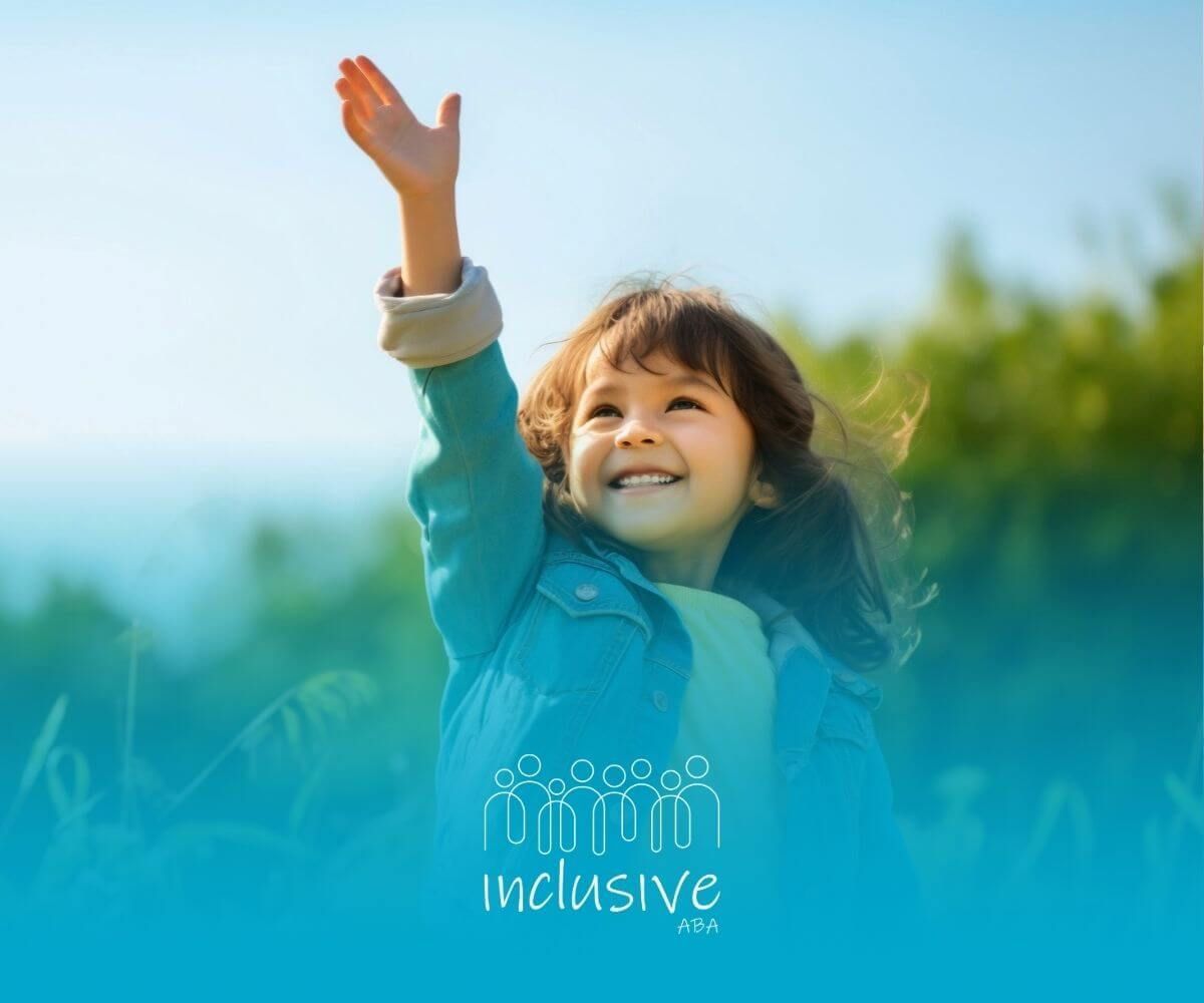 A little girl in a denim jacket is waving her hand in the air after attending ABA therapy.