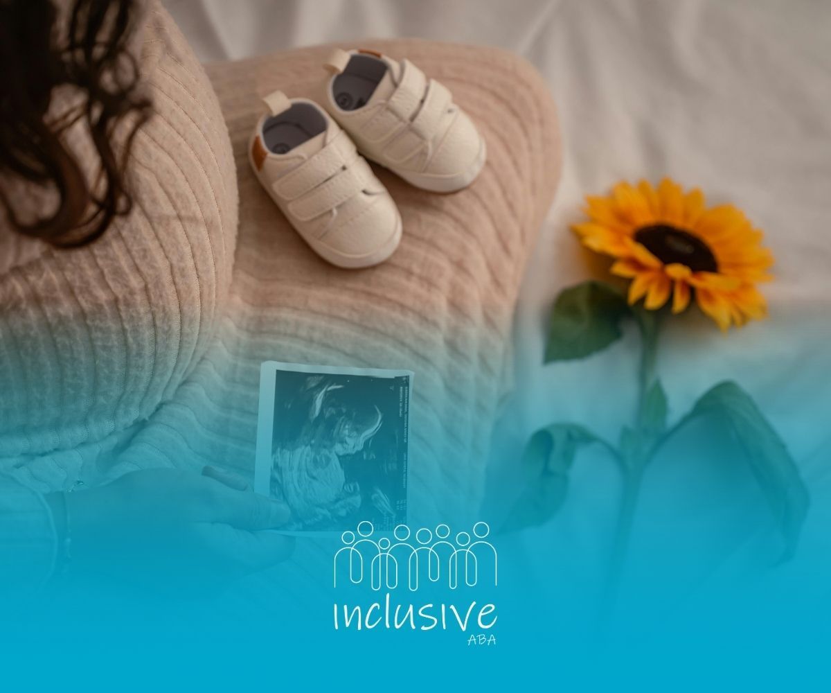 Pregnant woman with baby shoes, ultrasound photo, and a sunflower.