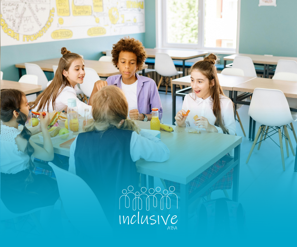 Students sitting at tables in a classroom, eating and talking.