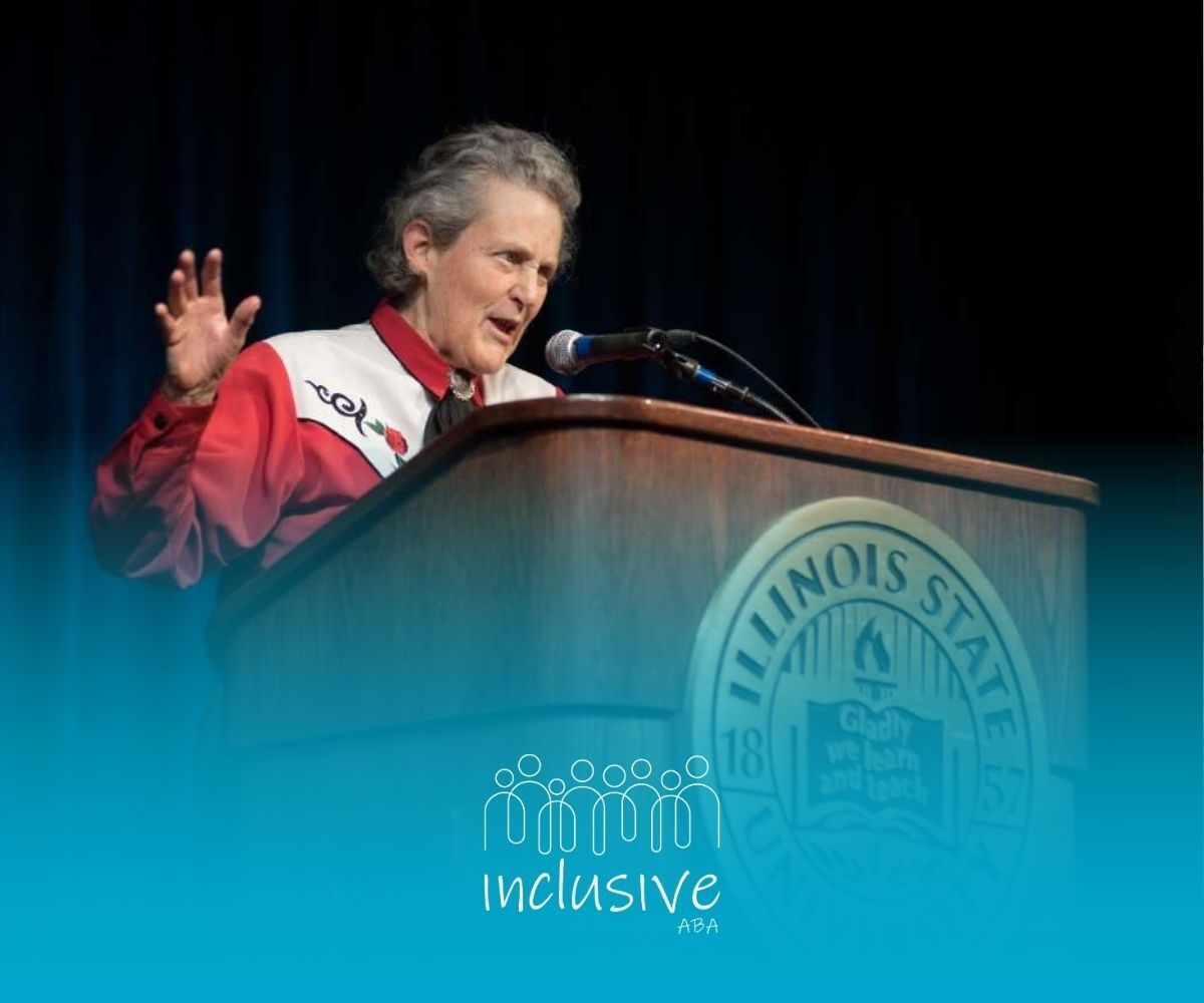 Temple Grandin speaks at a podium in Illinois State University giving a lecture about autism.