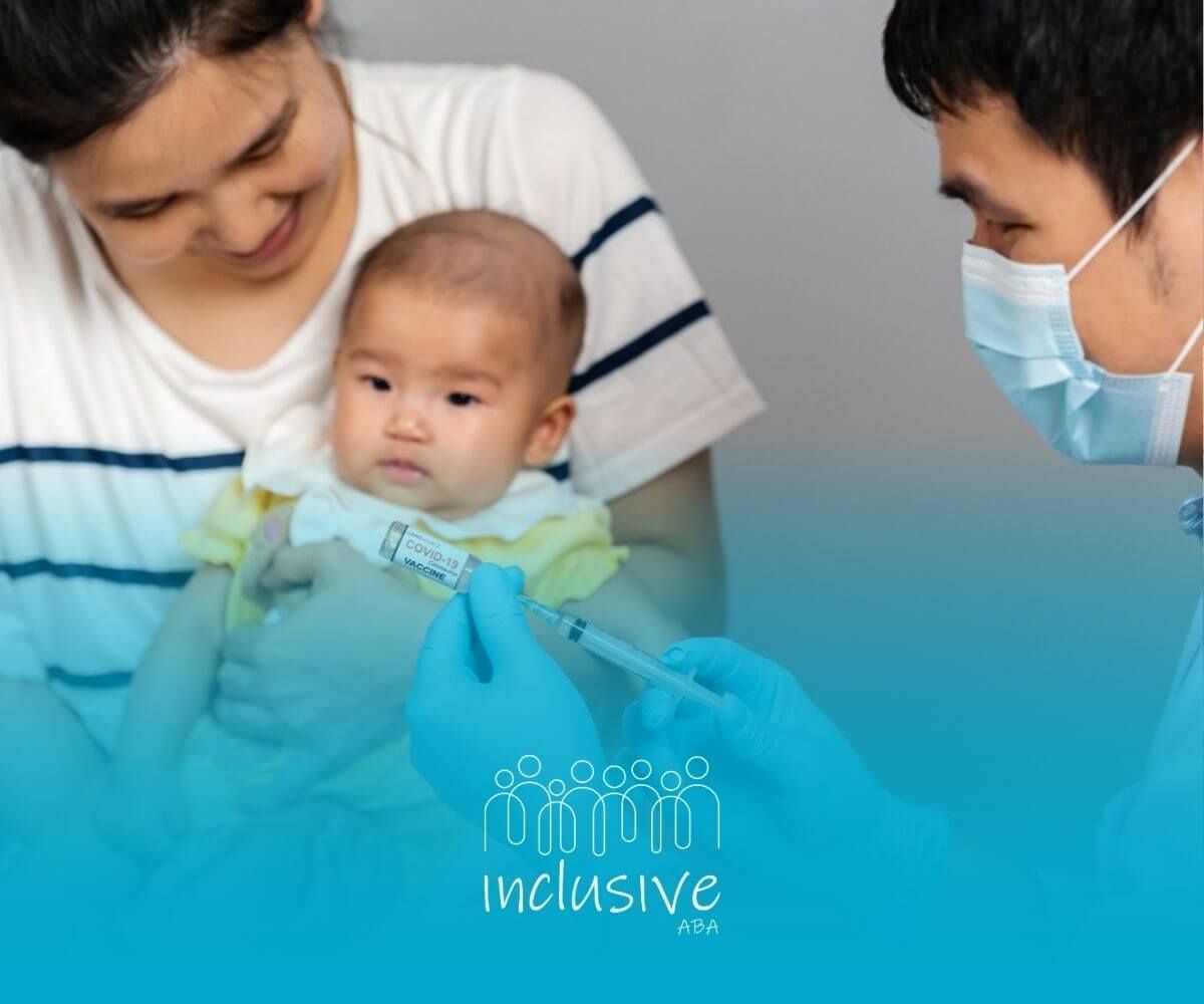 A woman is holding a baby while a doctor gives it an injection.